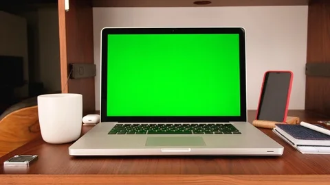 Laptop computer with a key green screen set on work home office table Stock Footage 128426224