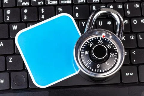 Laptop computer keyboard, a number code combination padlock and a blank empty 写真素材