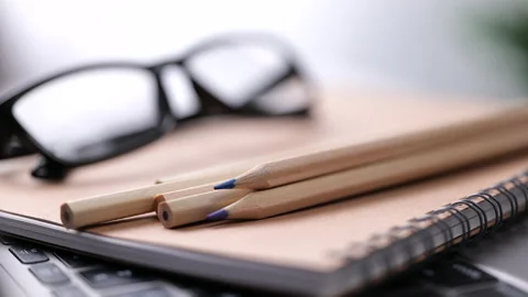 Laptop computer keyboard with pencil and glasses. Education concept Stock Footage 166103666