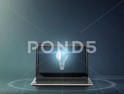 Laptop computer with light bulb on screen Stock Photos