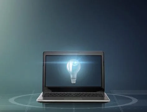 Laptop computer with light bulb on screen Stock Photos