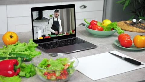 Laptop computer with man chef food blogger slices cucumber tells teaches student Stock Footage 164872230