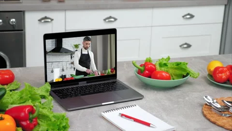 Laptop computer with man chef food blogger slices cucumber tells teaches student Video stock 167517683