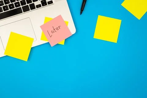 Laptop computer with many sticky notes on a blue background, flat lay. 写真素材