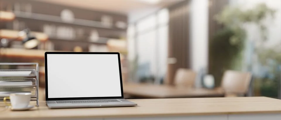 A laptop computer mockup on a table with a blurred background of a contempo.. Stock Illustration