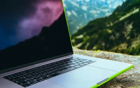 Laptop computer at the natural mountain background. Photo depicts notebook co Stock Photos