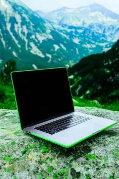 Laptop computer at the natural mountain background. Photo depicts notebook co 스톡 사진