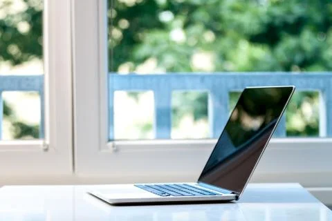 Laptop computer near the window Stock Photos