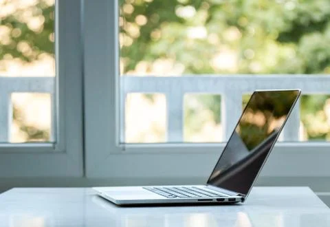 Laptop computer near the window Stock-Fotos