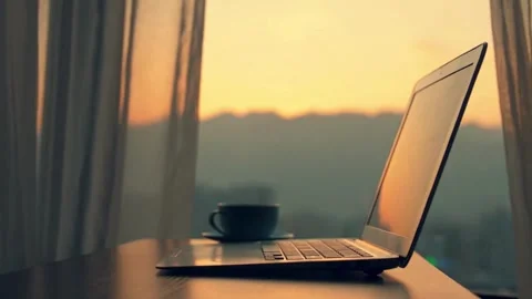 Laptop Computer Near Window at Sunrise with Coffee Cup Stock Footage 309543884