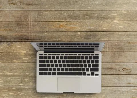 Laptop computer with notebook and cup of coffee on wooden desktop Stock Photos
