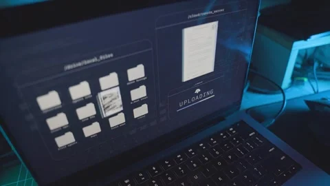Laptop computer on office desk uploading top secret classified files onto server Stock Footage 328026653