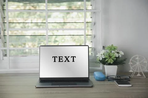 The laptop computer is placed on a wooden table 스톡 사진