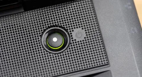 Laptop computer power button LED light indicator glowing green PC turned on.. Stock Photos