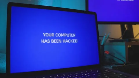 Laptop computer screen glitches and shows hacking message in dark office room Stock Footage 328026561