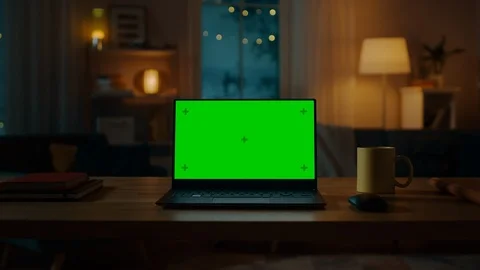 Laptop Computer Showing Green Chroma Key Screen Stands on a Desk in Living Room Stock Footage 99069939
