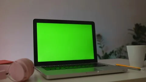Laptop Computer Showing Green Chroma Key Screen Stands on a Desk in the Living Stock Footage 114061791
