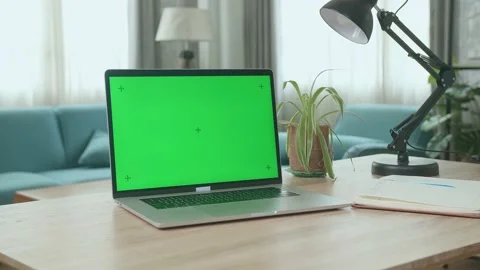Laptop Computer Showing Green Key Screen Stands On A Desk In The Living Room Video stock 162995606