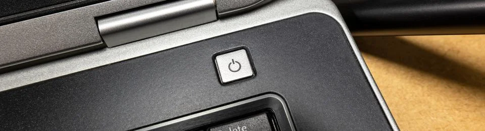 Laptop computer simple silver power button, switch, object detail, closeup Stock Photos