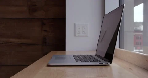 Laptop computer sitting on bench overlooking city - rack focus Stock Footage 148245255
