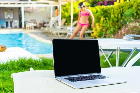 Laptop computer on table pool background Stock Photos