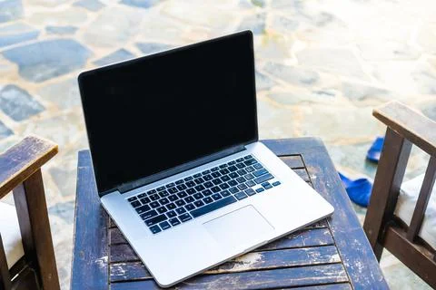Laptop computer on table pool background Stock Photos