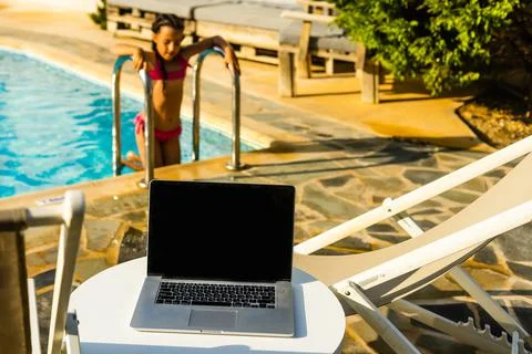 Laptop computer on table pool background Stock Photos