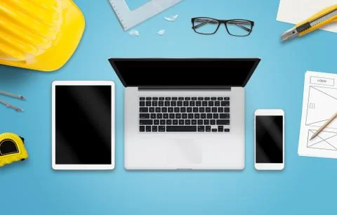 Laptop computer, tablet and smart phone on designer desk. Mockup for responsi Stock Photos