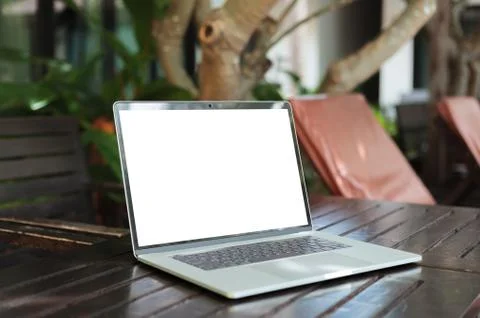 Laptop computer white screen on table resort view background Stock Photos