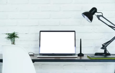 Laptop computer white screen on workspace Stock Photos