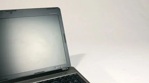 LAPTOP COMPUTER ON WHITE TRACKING SHOT Stock Footage 10727633