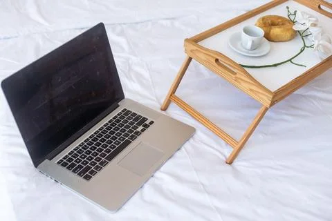 Laptop computer, wooden table with a cup of coffee next to it. Working from home Stock Photos