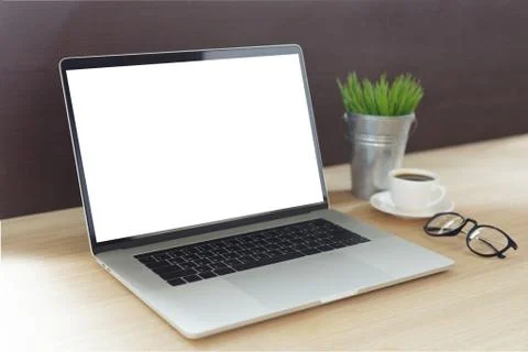 Laptop computer on work desk showing white screen side view Stock Photos