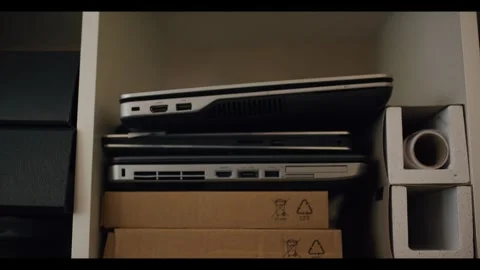 Laptop Computers Piled on Office Storage Shelf, Cardboard Boxes, Medium Shot Stock Footage 340298574