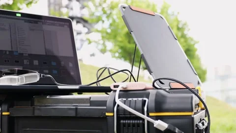 Laptop connected to portable solar panel. Video stock 157589631