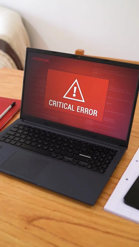 Laptop with critical error message on red screen. Concept of system alert Stock Footage 306134913