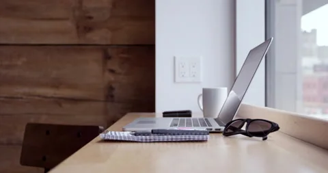 Laptop with cup of coffee and note pad sits in front of window - work from an Stock Footage 148245343