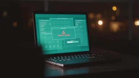Laptop on desk at night showing server hacking attempt detected by system Stock Footage 330739800