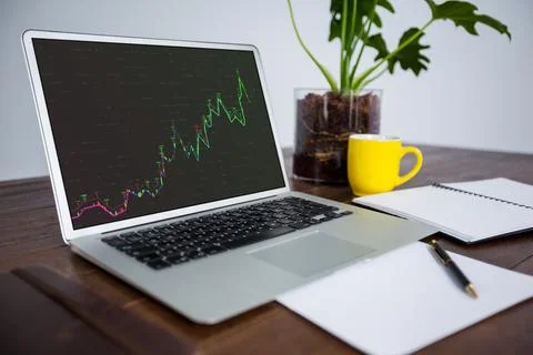 Laptop on desk with statistical data on screen Stockillustratie