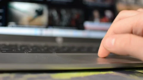 Laptop device. man's hand scroll youtube social media app on laptop screen. Video stock 302344935