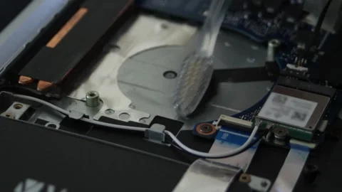 Laptop diagnostics. The soft brush removes dust where the fan used to be Stock Footage 297071507