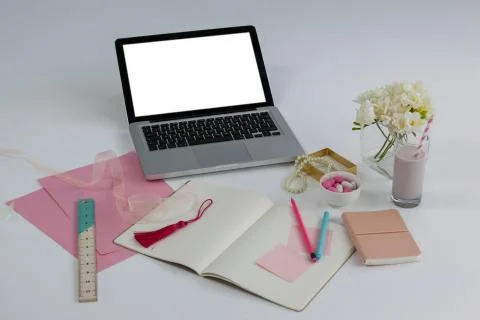 Laptop, diary, ruler, pages, sticky notes, flowers and pencil Stock Photos