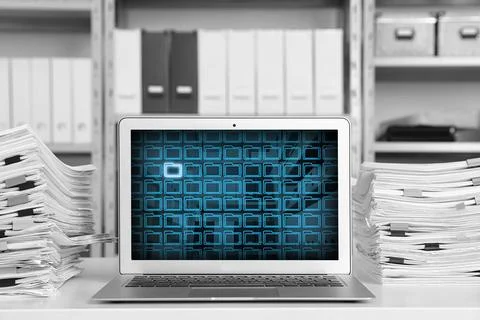 Laptop with digital archive program in office. Many folder icons and one hi.. Stock Photos
