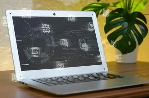 Laptop with Digital Interface and Plant Background in Modern Workspace Foto stock