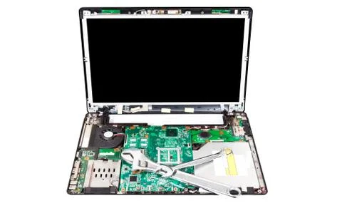 Laptop disassembled with two wrenches on it Stock Photos