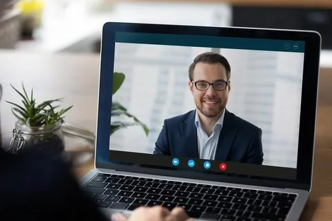 Laptop display with interface of video call to happy businessman Stock Photos