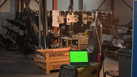 Laptop Displaying Green Screen Mockup on Welding Machine in Factory Stock Footage 342501509