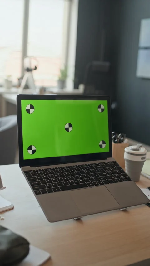 Laptop Displaying Green Screen with Tracking Markers on Office Desk Stock Footage 338336912