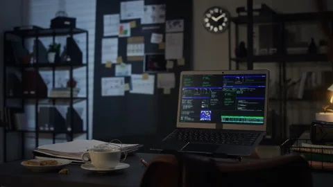 Laptop Displaying Programming Code on Desk in Dark Office at Night Stock Footage 338412567