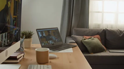 Laptop Displaying Video Editing Software on Home Office Desk Stock Footage 347657339